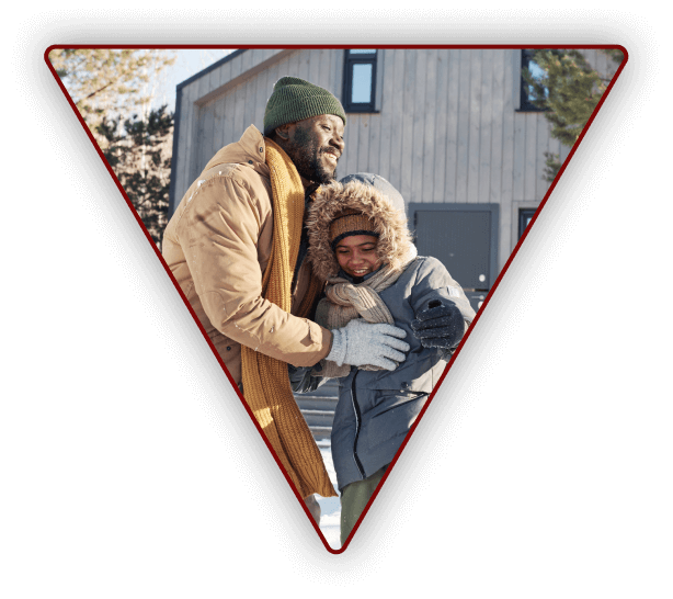 Father and child having fun playing outside in the winter