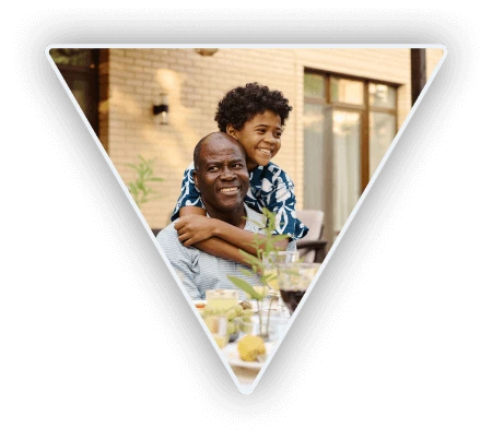 Triangle cut out of a photo of a father and son enjoying their outdoor patio without being bothered by bugs thanks to Mosquito Mike.