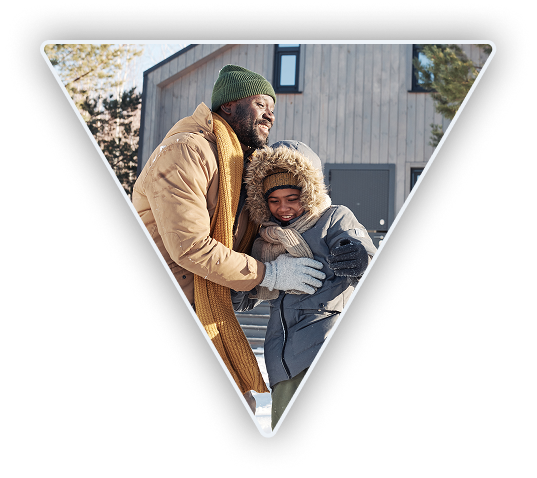 Father and child having fun playing outside in the winter