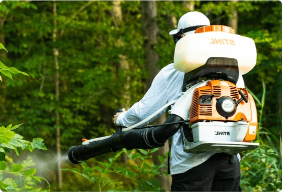 Close view of man spraying for mosquitos
